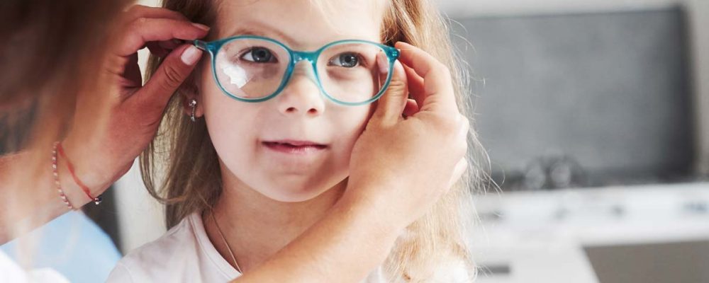 young girl receiving glasses