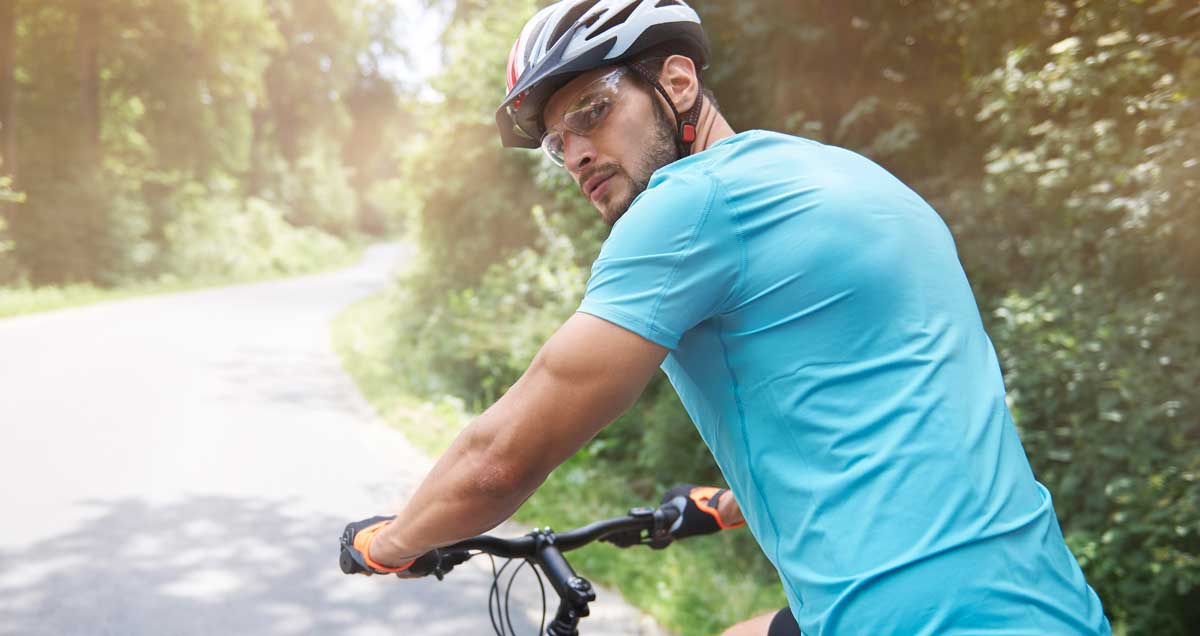 man cycling wearing sports glasses